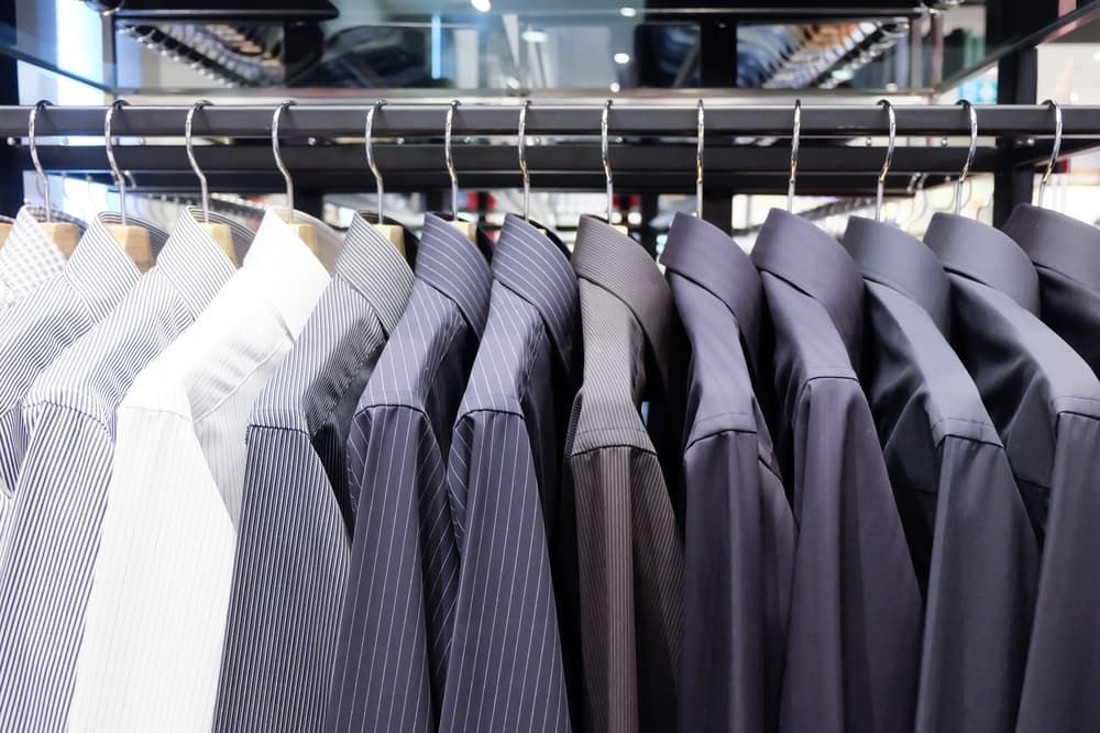 A Row of Shirts Hanging on A Rack in A Store — New Park Suit Hire & Menswear in Townsville, QLD