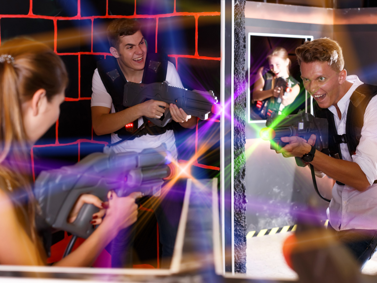 A man and a woman are playing a game of laser tag.