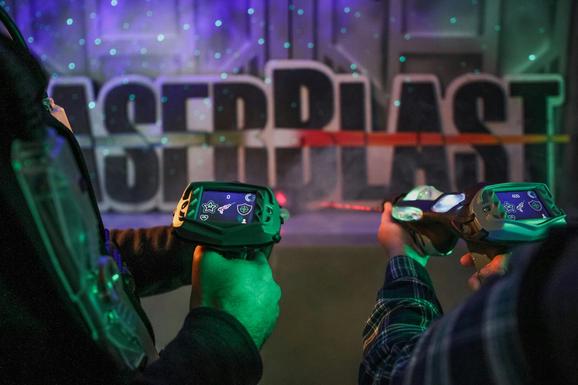 Two people holding laser tag guns with