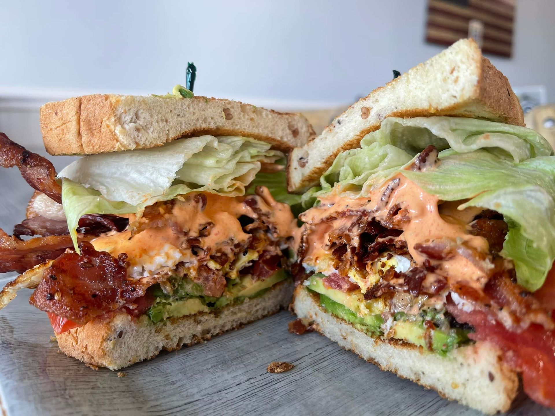 Grilled sandwich halves with lettuce and melted cheese on a plate