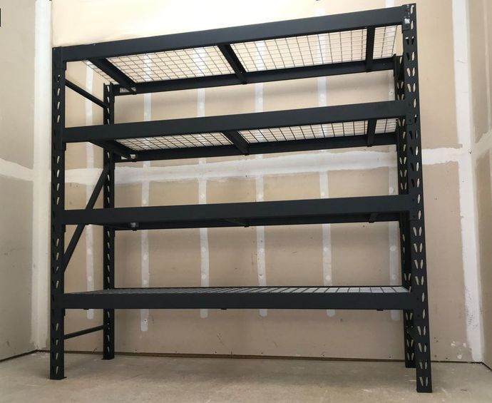 A black metal shelf in a corner of a room