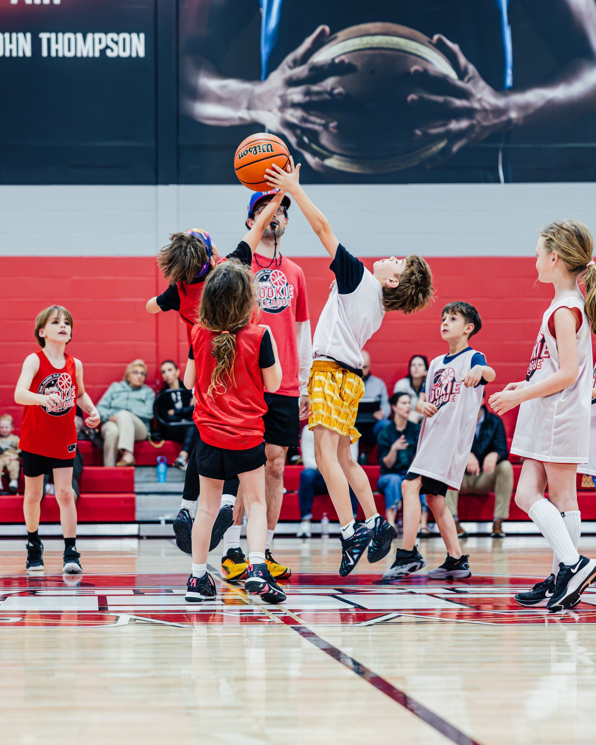 Red and white basketball camp flyer with a child dribbling, dates, time, price, and QR code.