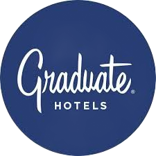 Graduate Hotels logo in white script on a blue circle