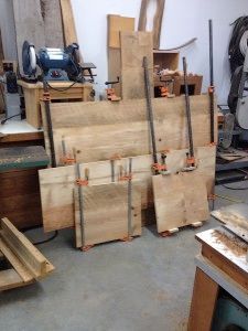 A pile of wood sitting on top of each other in a workshop.