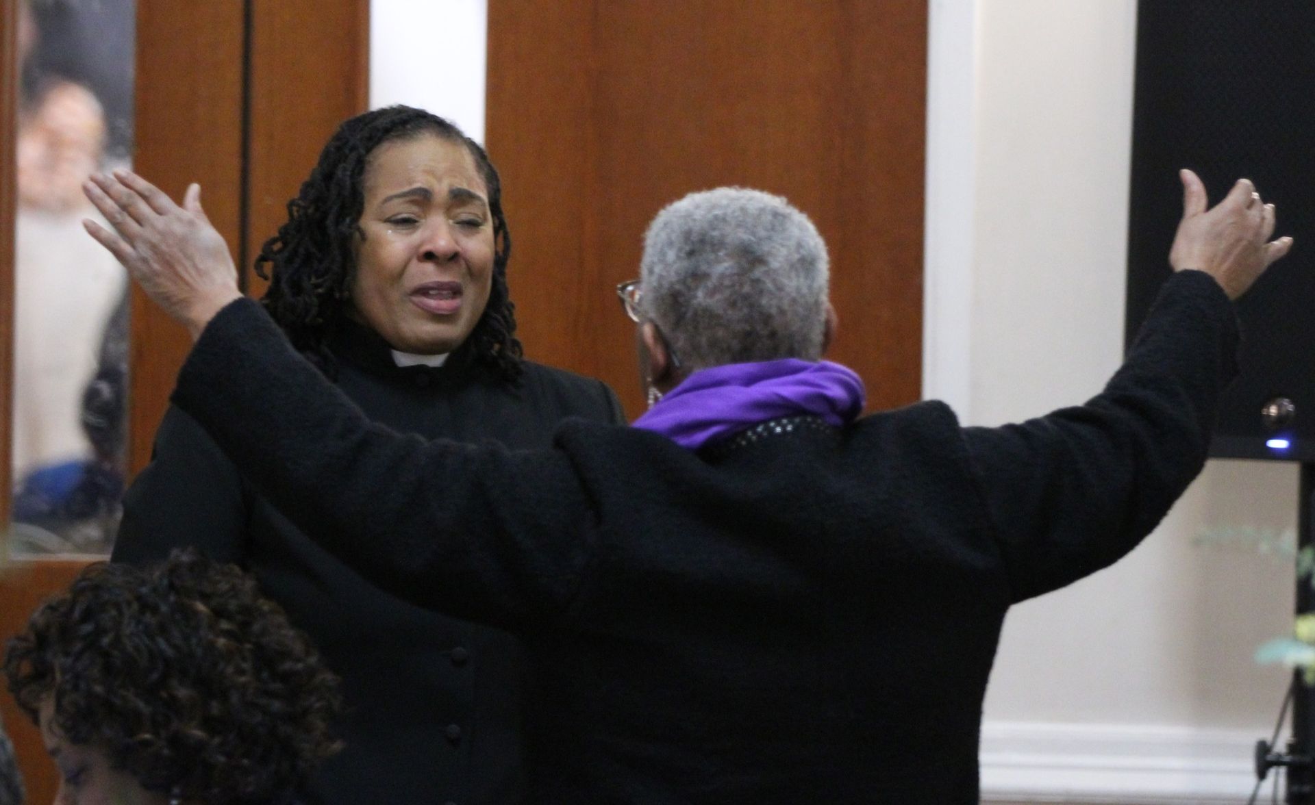 A man and a woman are standing next to each other with their arms outstretched