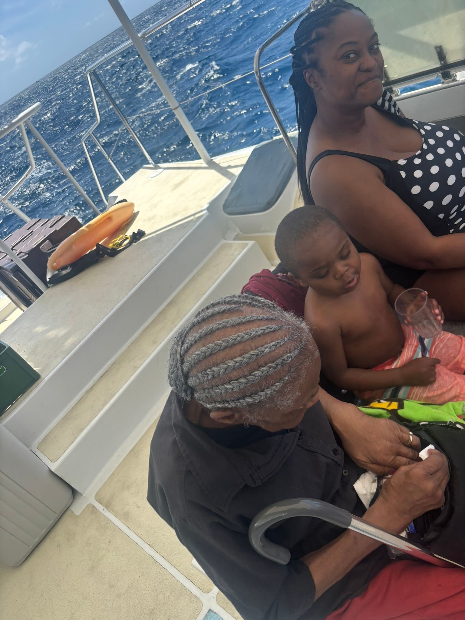 A woman and a child are sitting on a boat in the ocean.