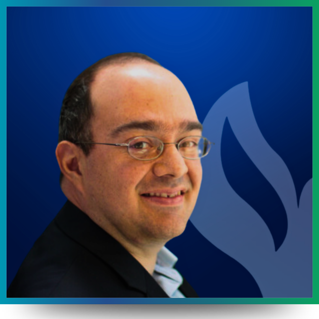 Leslie Babel smiling in front of a blue background