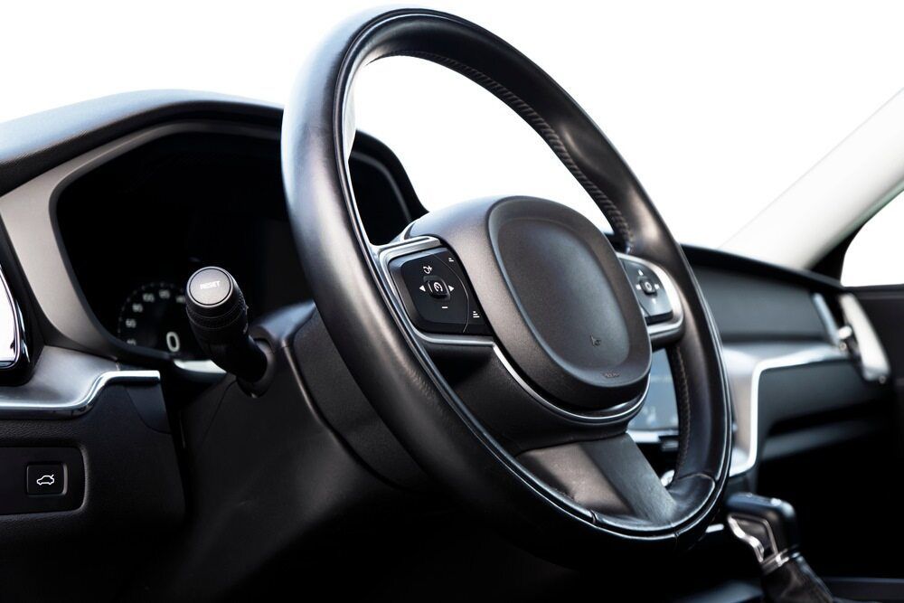 A Close Up Of A Car Steering Wheel On A White Background — Dore's Goodyear Autocare Tully In Tully, QLD