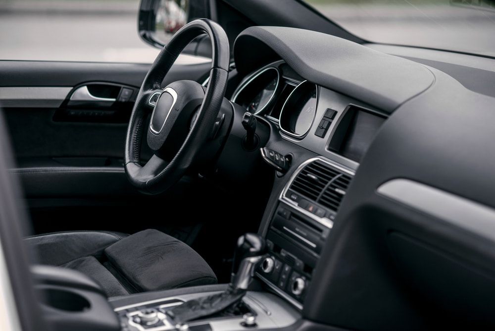 The Interior Of A Car With A Steering Wheel And Dashboard — Dore's Goodyear Autocare Tully In Tully, QLD