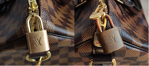 Close-up of a brown monogram bag with a gold lock and zipper hardware.
