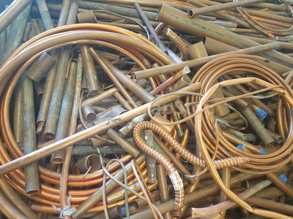 Pile of copper tubing scraps, in various shapes and sizes.