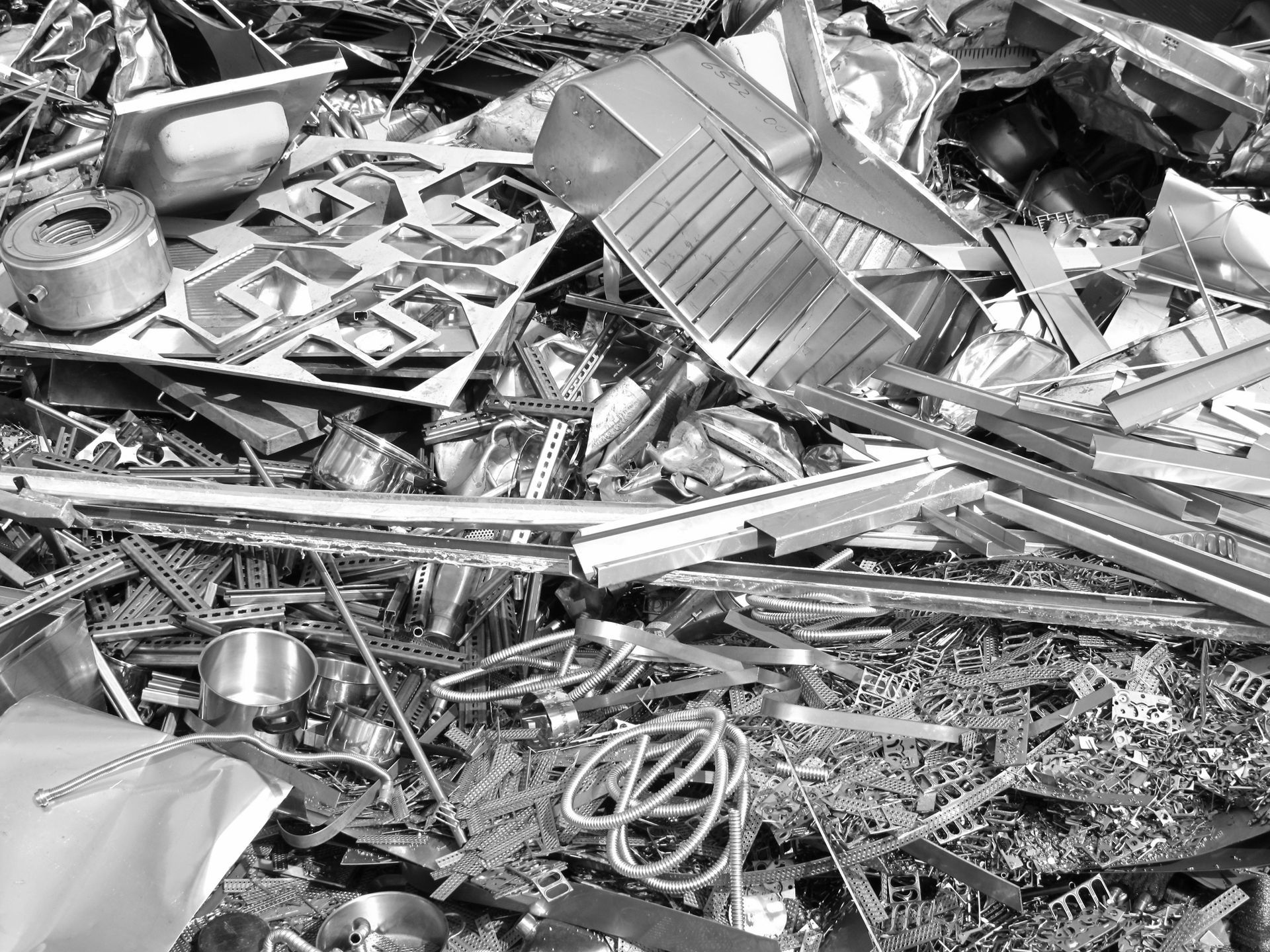 A pile of scrap metal is sitting on the ground.