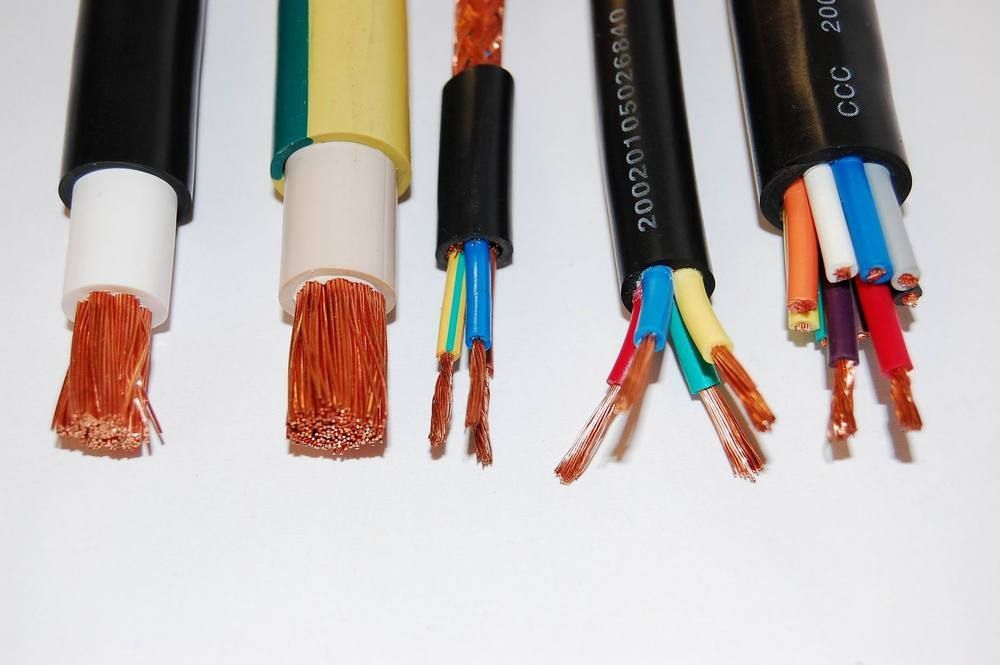 Various electrical cables, with exposed copper wires and different colored insulation.