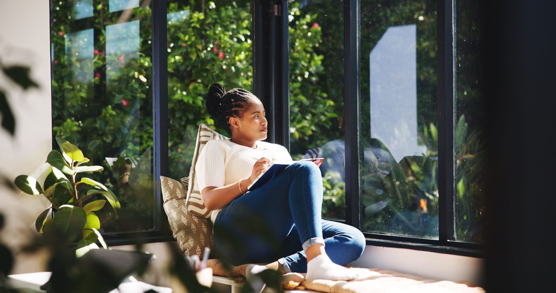 Person sitting calmly by a window, reflecting on whether it is time to seek therapy in Grimsby, ON