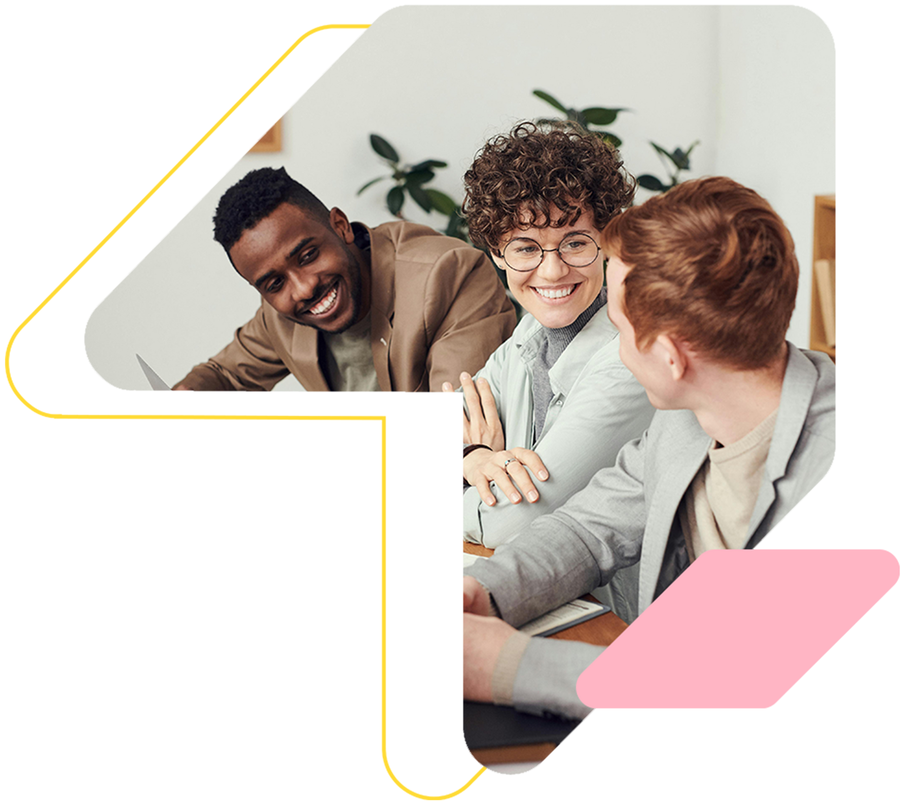 Three diverse colleagues laughing, working together in an office.