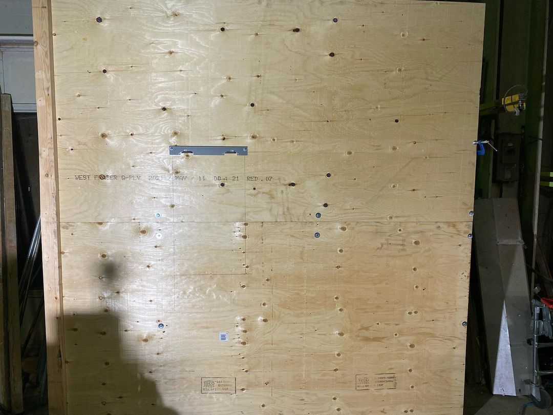 A large piece of plywood is sitting on a table in a room.