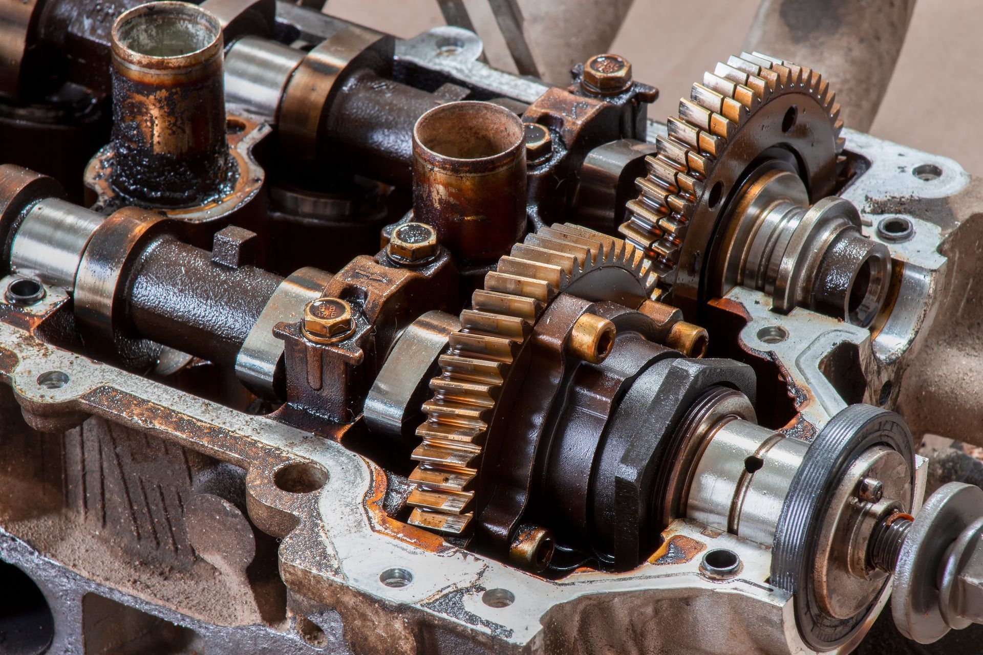Close-up of rusty engine gears and camshafts inside a metal machine housing