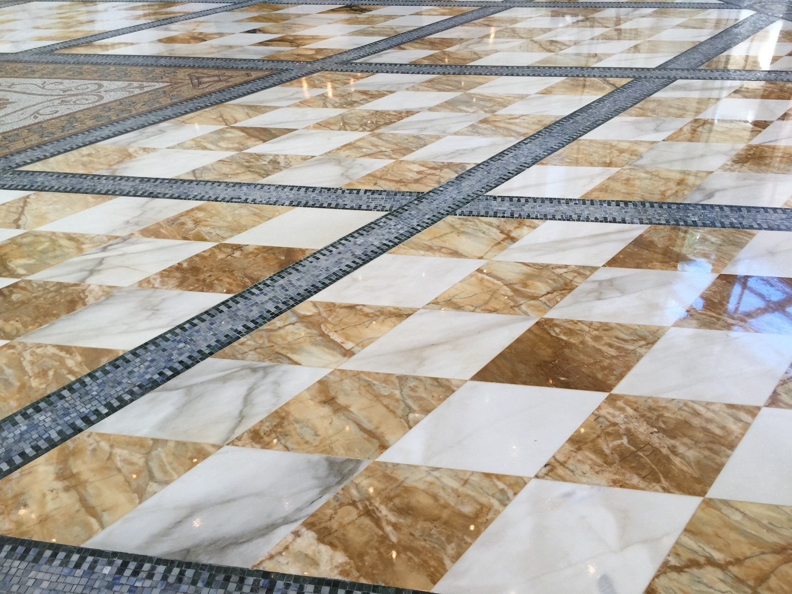 A close up of a marble floor with a checkered pattern.