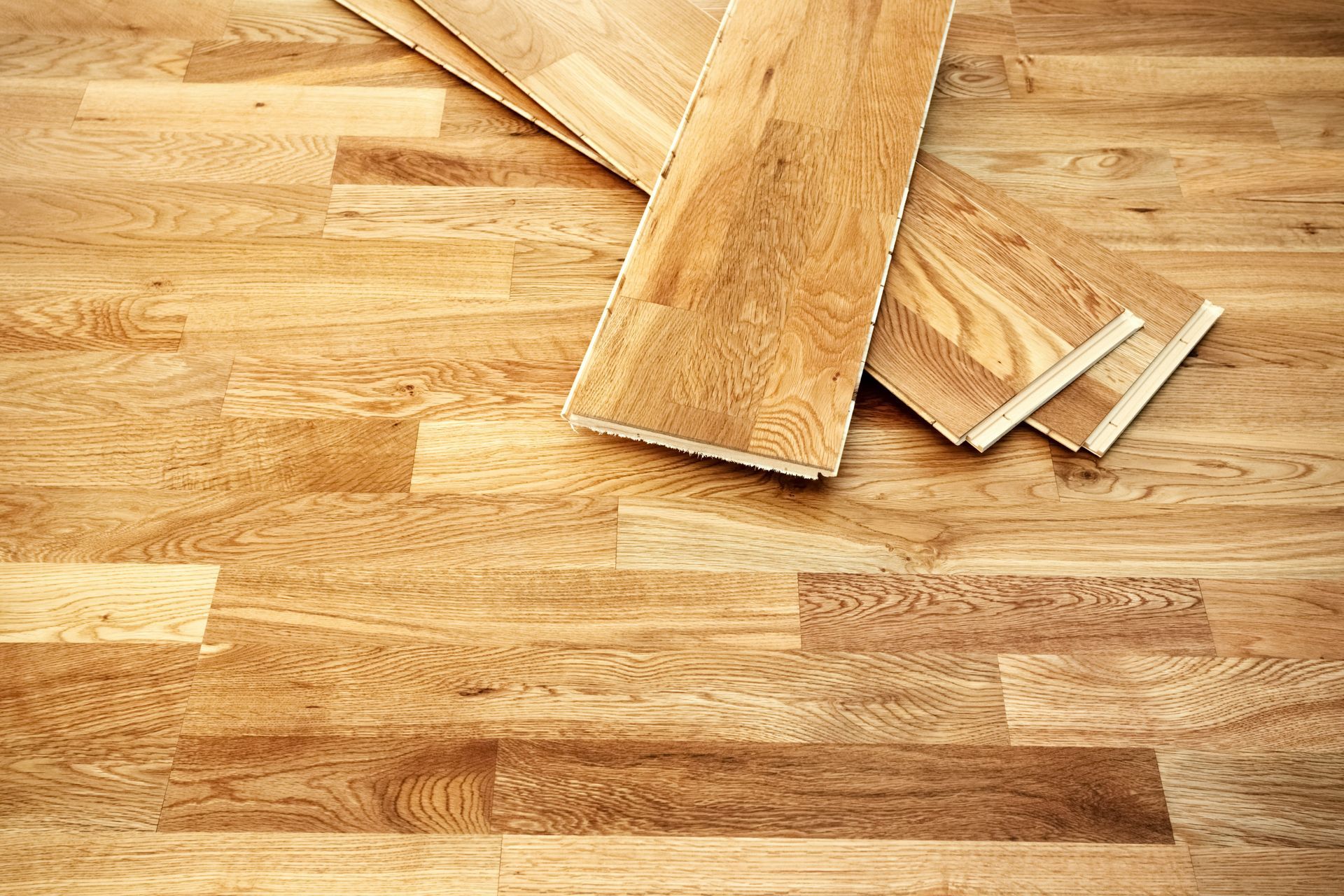 Close view of engineered flooring click planks on top of a floor.