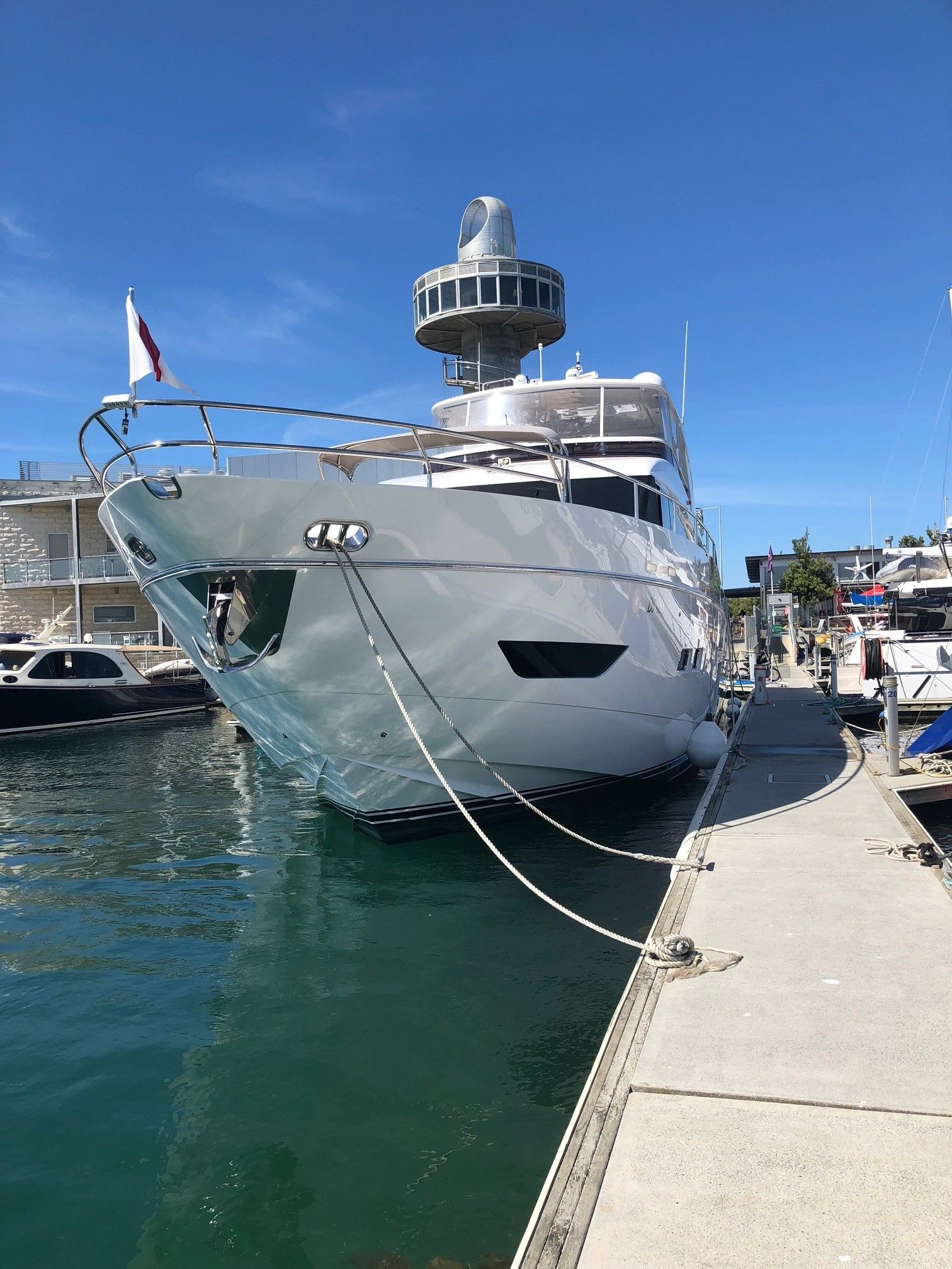 A man is washing a boat with a high pressure washer.