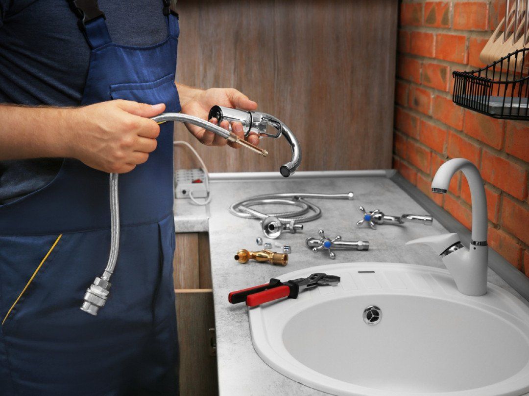Man repairing and cleaning the sink