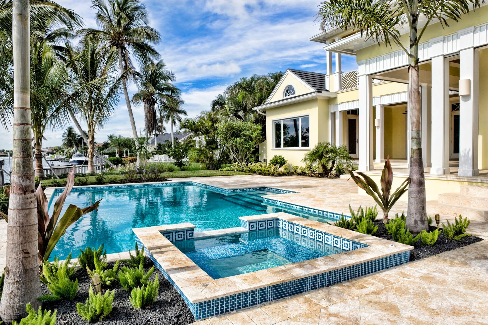 A large house with a large swimming pool in front of it