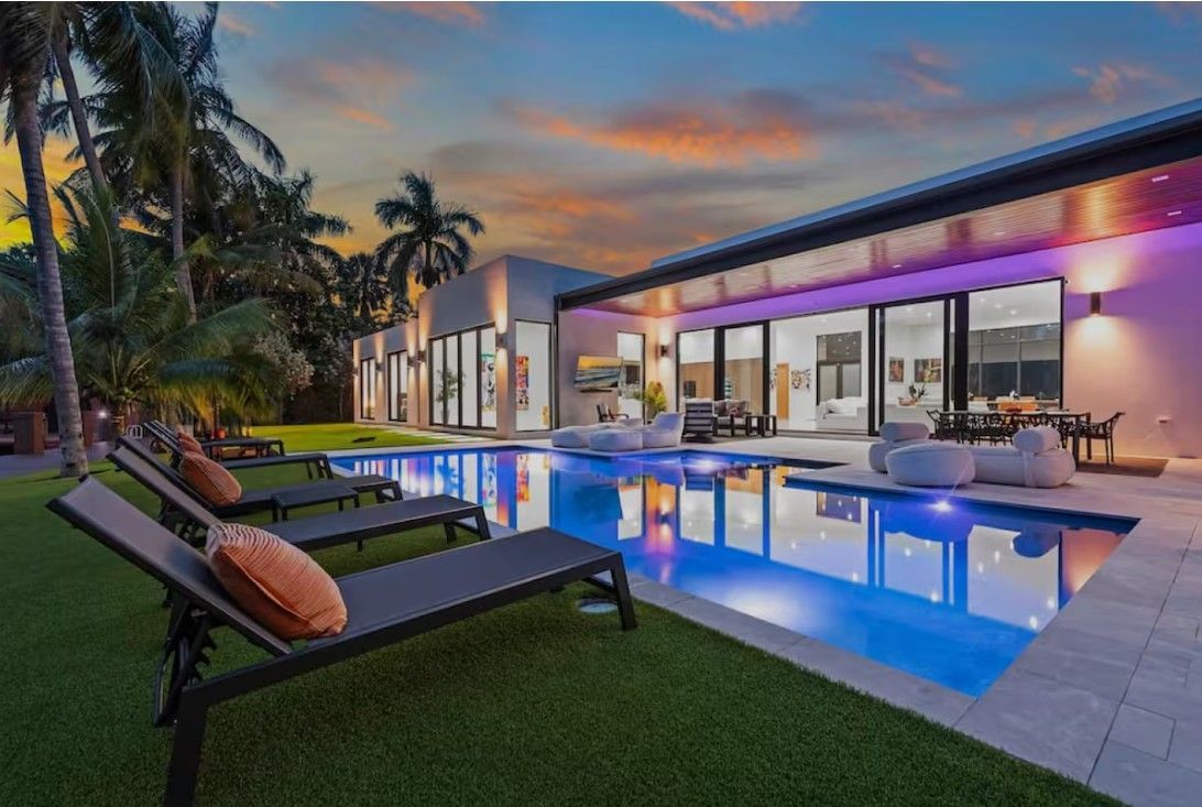 South Florida luxury home with pool and palm trees spring market