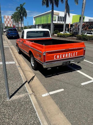 An Orange Chevrolet Truck Is Parked On The Side Of The Road — Townsville Car Care Centre In Aitkenvale, QLD