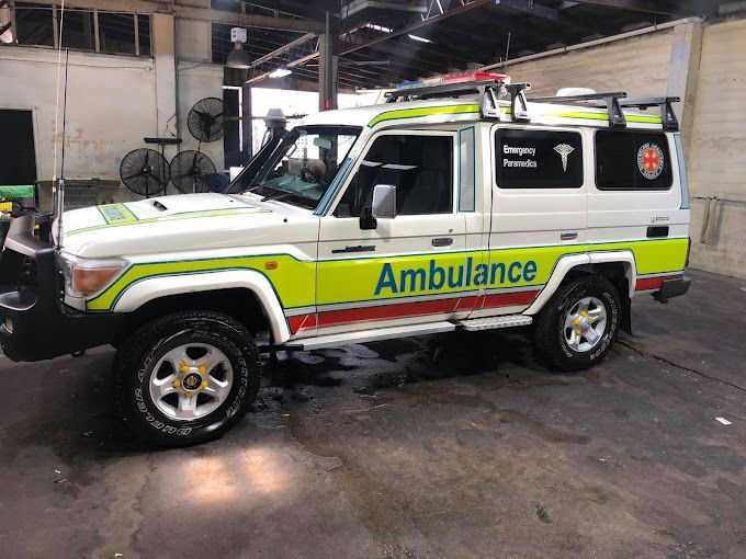 A White And Yellow Ambulance Is Parked In A Garage — Townsville Car Care Centre In Aitkenvale, QLD