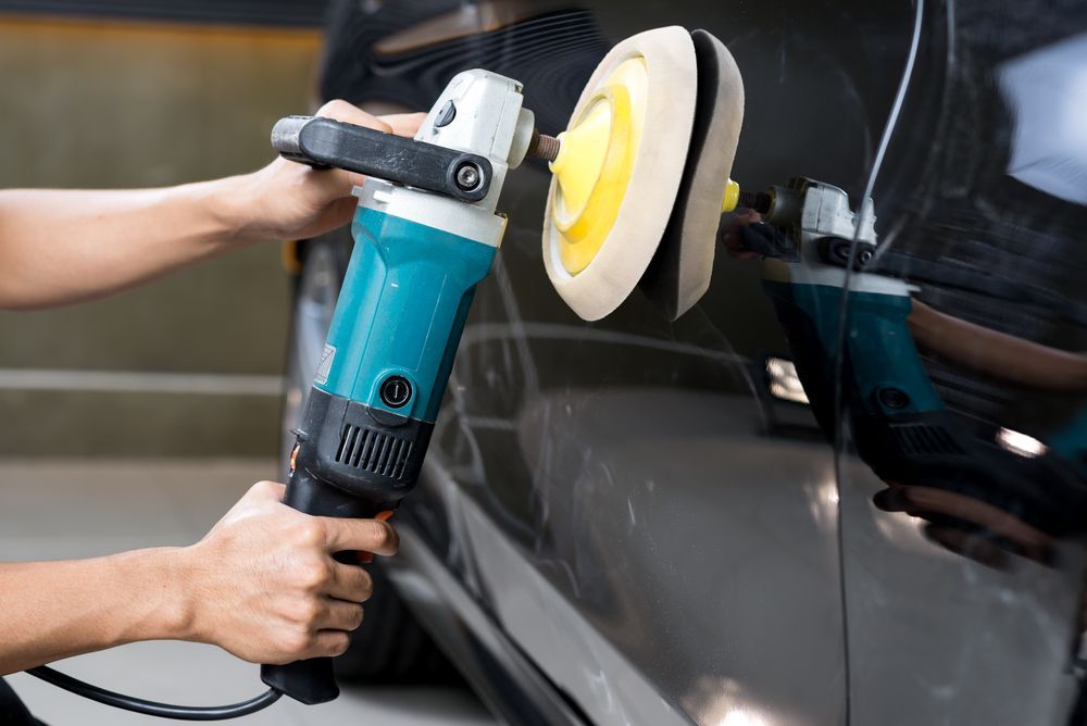 A Person Is Polishing A Car With A Machine — Townsville Car Care Centre In Aitkenvale, QLD