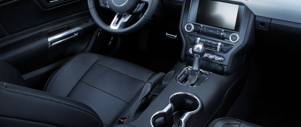 The Interior Of A Ford Mustang With Black Leather Seats And A Cup Holder — Townsville Car Care Centre In Aitkenvale, QLD