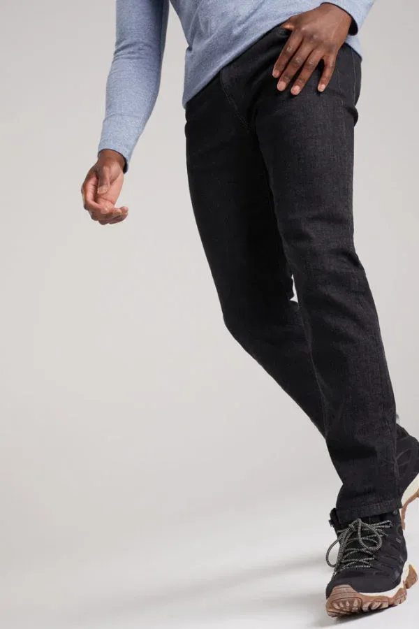 A man wearing a blue shirt and black jeans