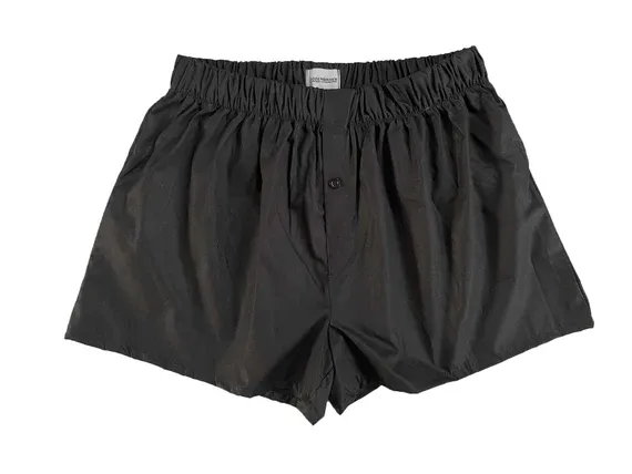 A pair of black boxer shorts on a white background