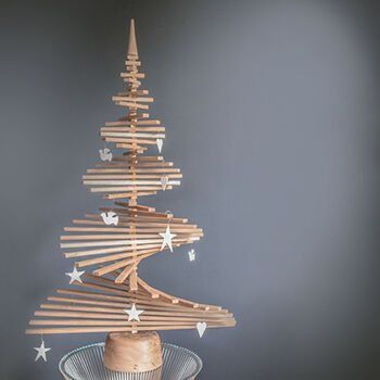 A wooden christmas tree with stars and hearts on it