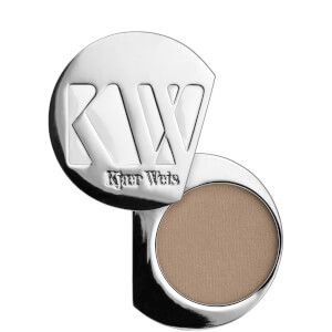 A close up of a kkw eyeshadow on a white background.