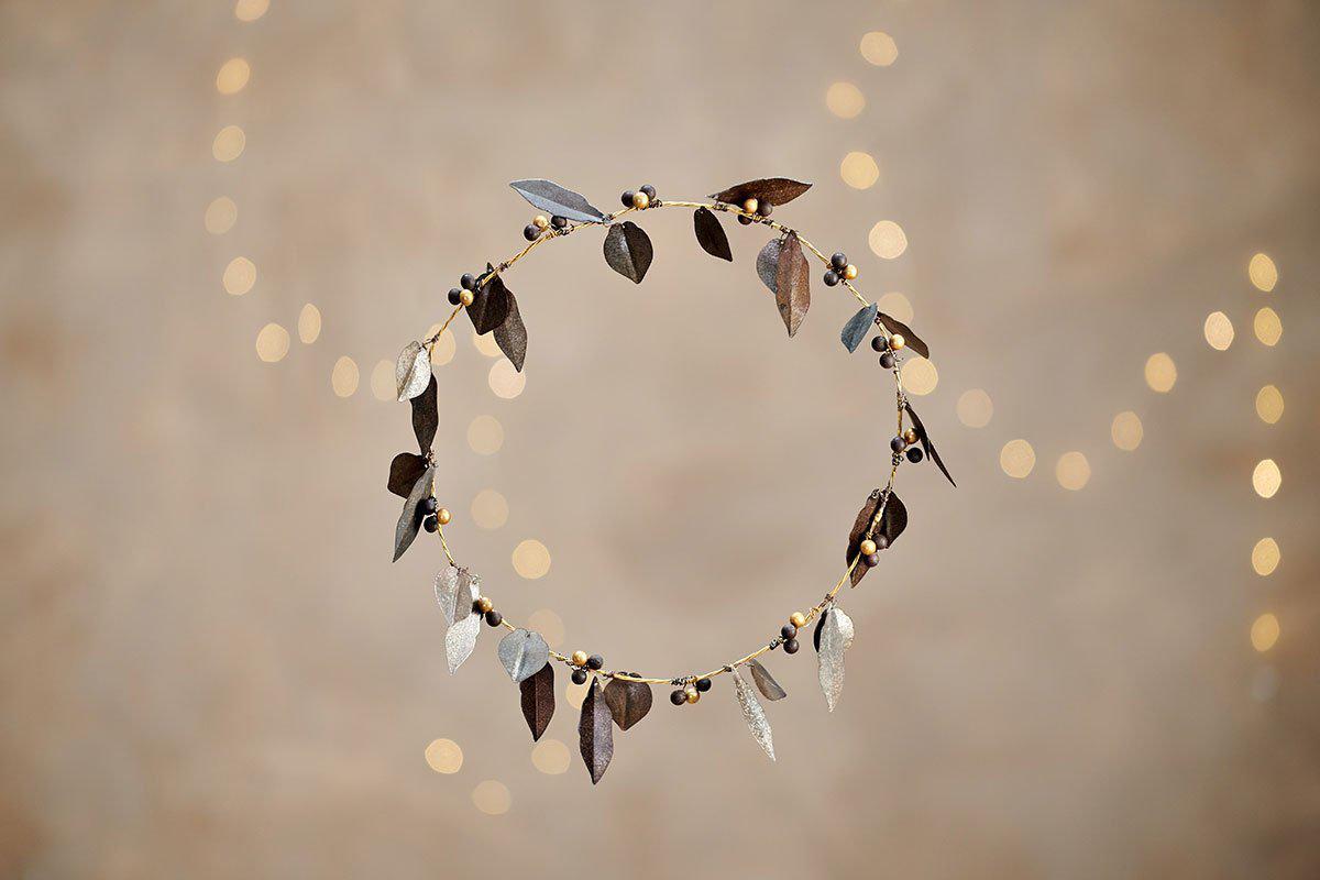 A wreath made of metal leaves and berries