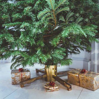 A christmas tree with gifts underneath it in a room.