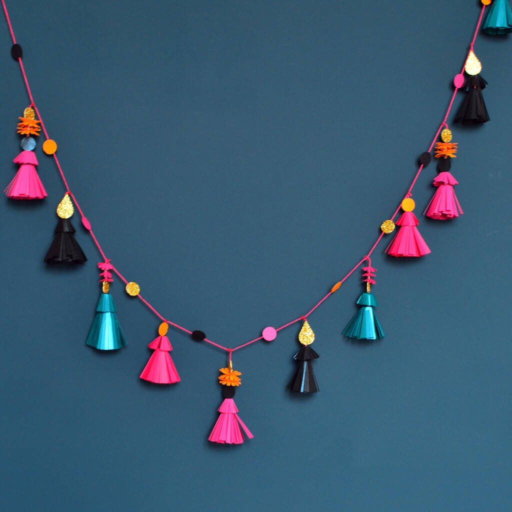 A string of pink and blue tassels on a blue background