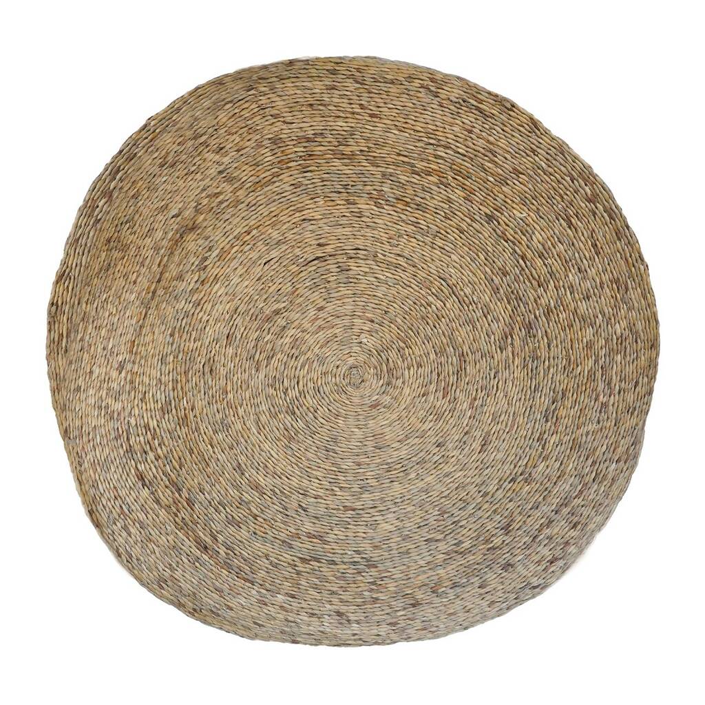 A round woven christmas tree rug with a circular pattern on a white background