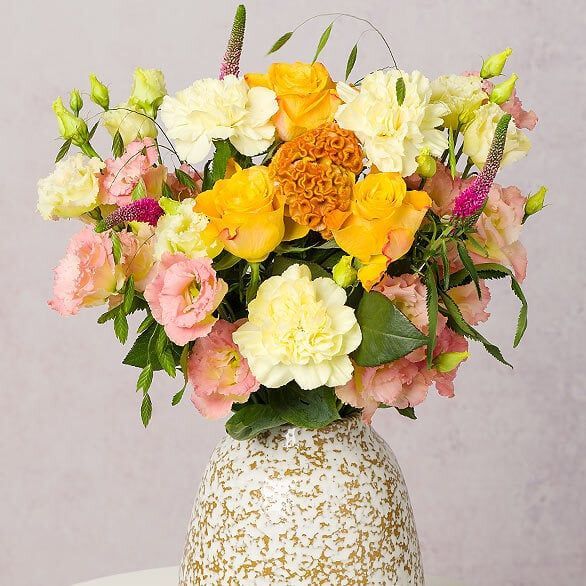 A vase filled with flowers is sitting on a table.