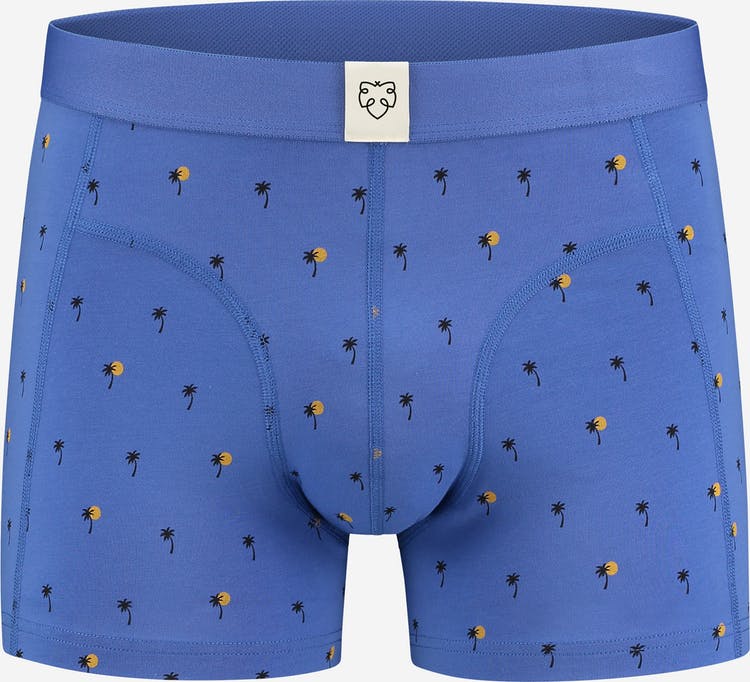 A pair of blue boxer shorts with palm trees on them