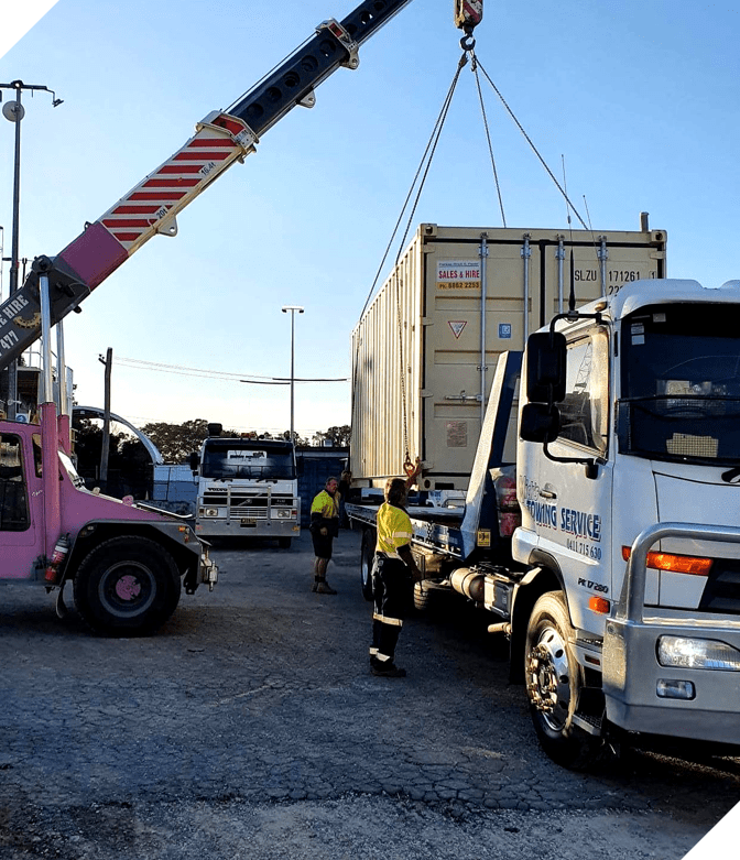 A Tow Truck With a Red Car on the Back — Mick’s Towing Service Pty Ltd in Carrara, QLD