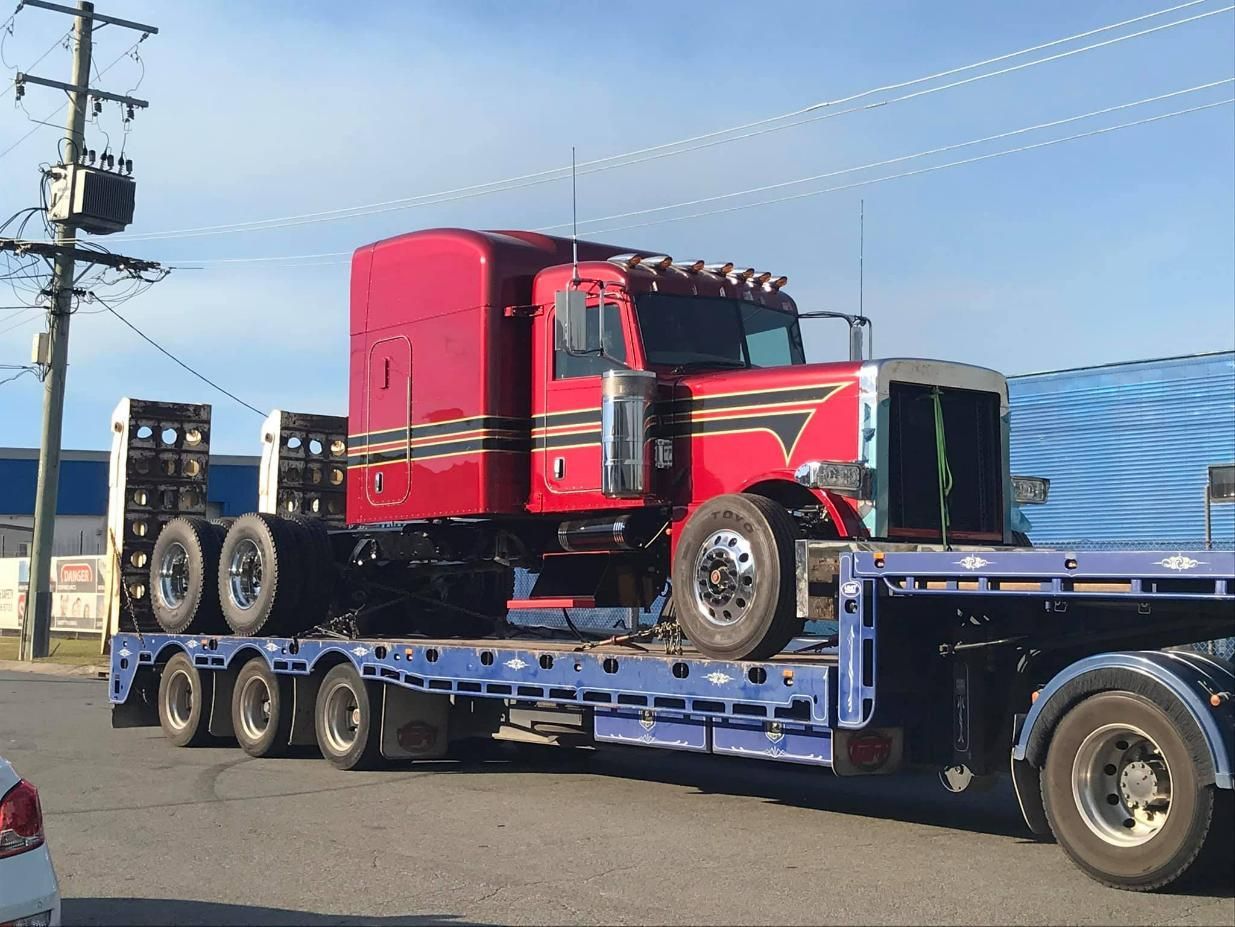 A long-haul truck being towed following a breakdown