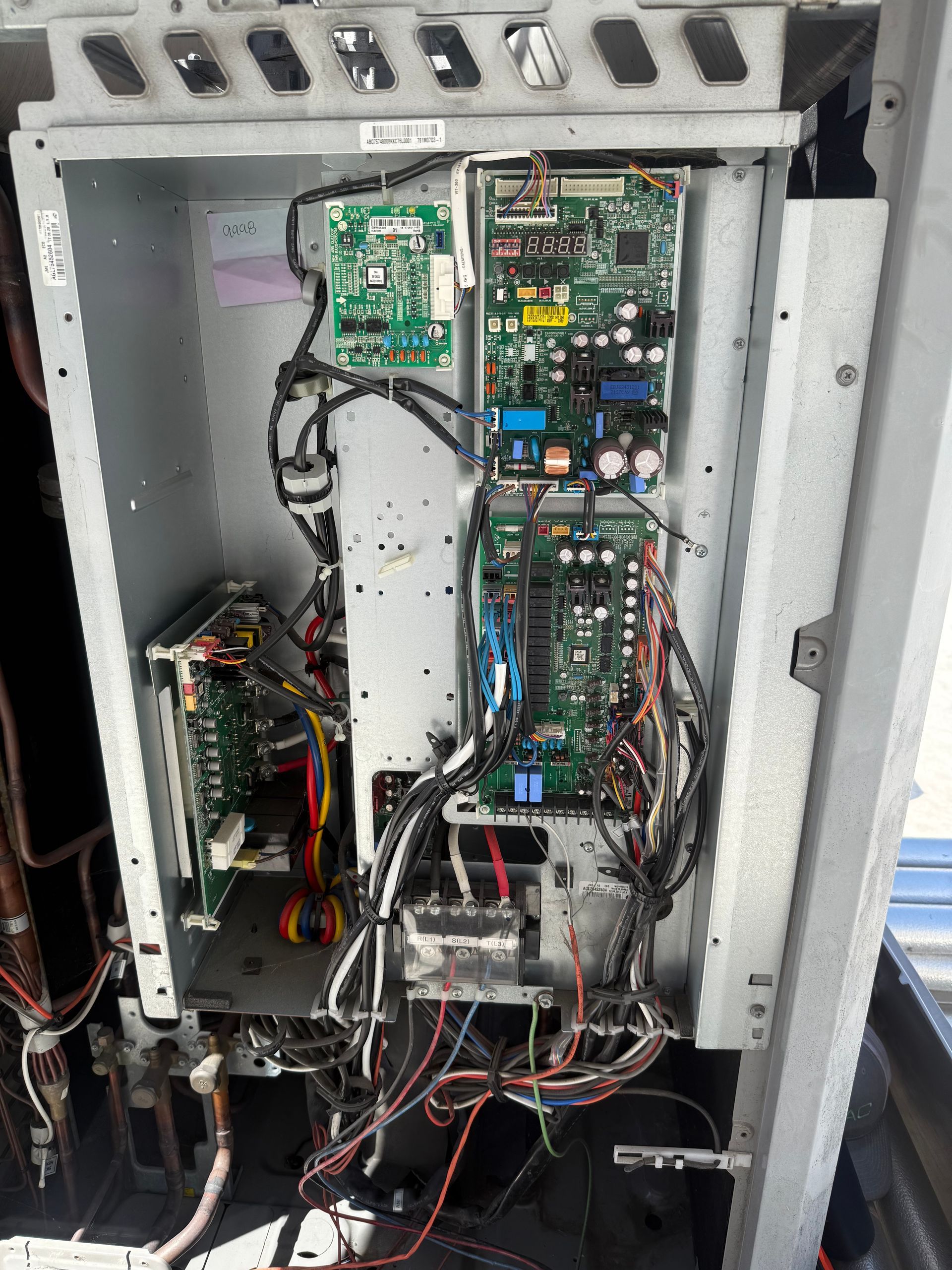 LG Multi V 5 open air-conditioning unit with multiple circuit boards, wires, and electronic components.
