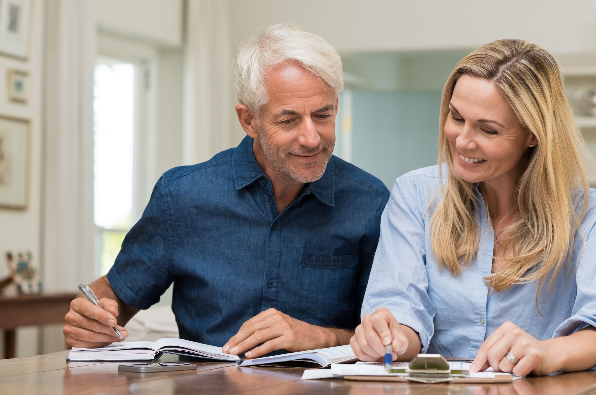 A couple reviews retirement planning documents.