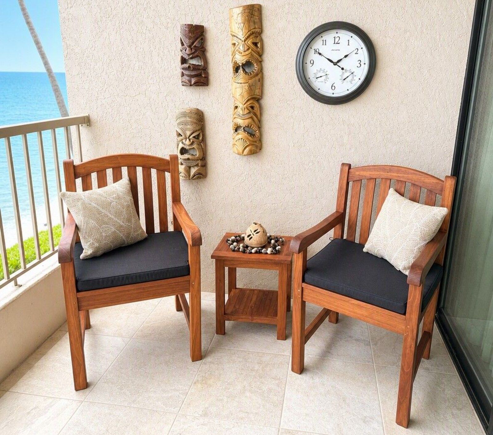 A22 lanai with two wooden swivel chairs and the ocean beyond