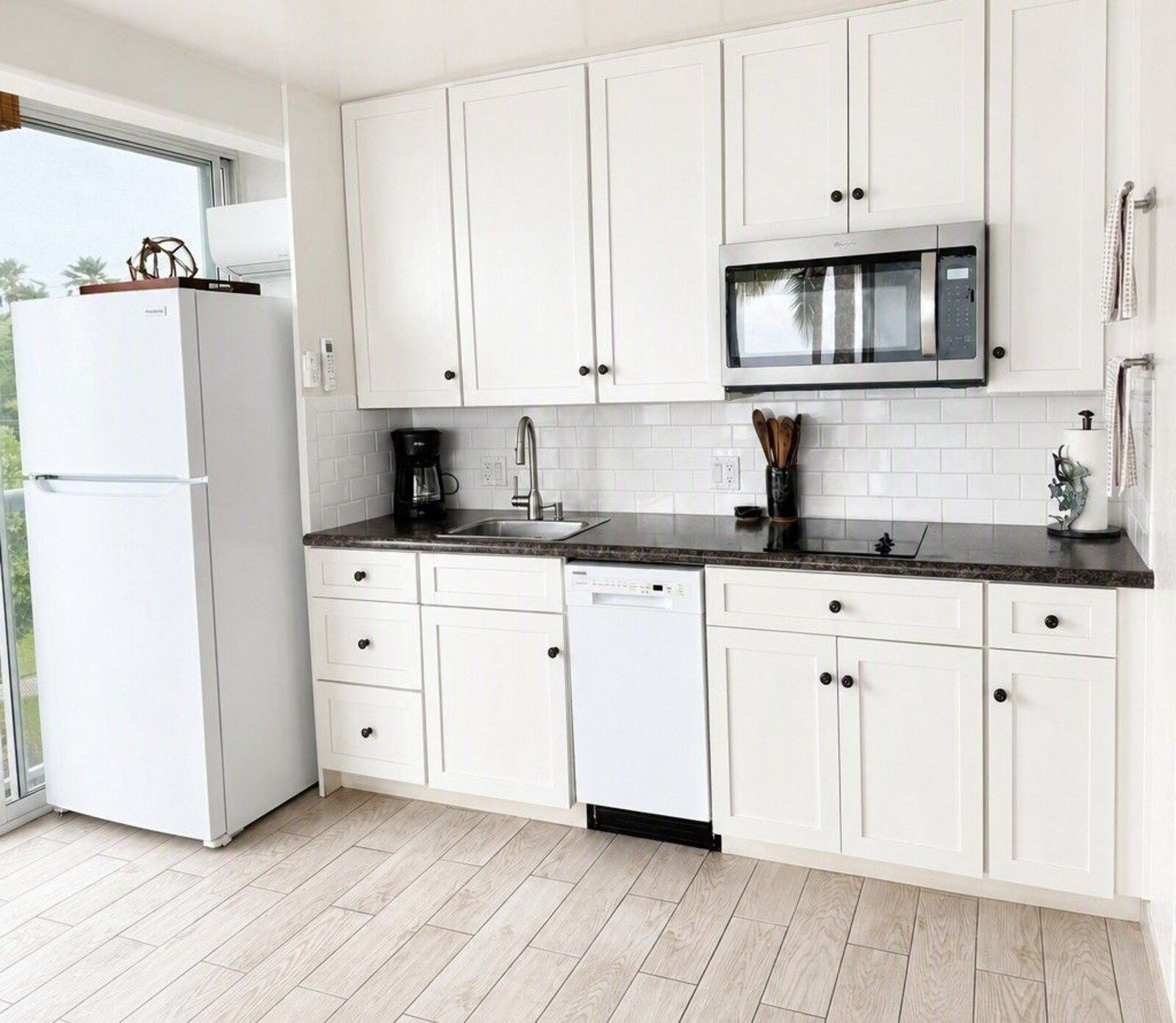 314 kitchen with white cabinets and full size refrigerator
