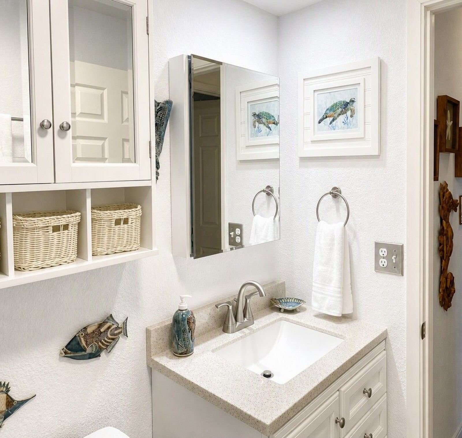 D24 bathroom with white vanity and framed art