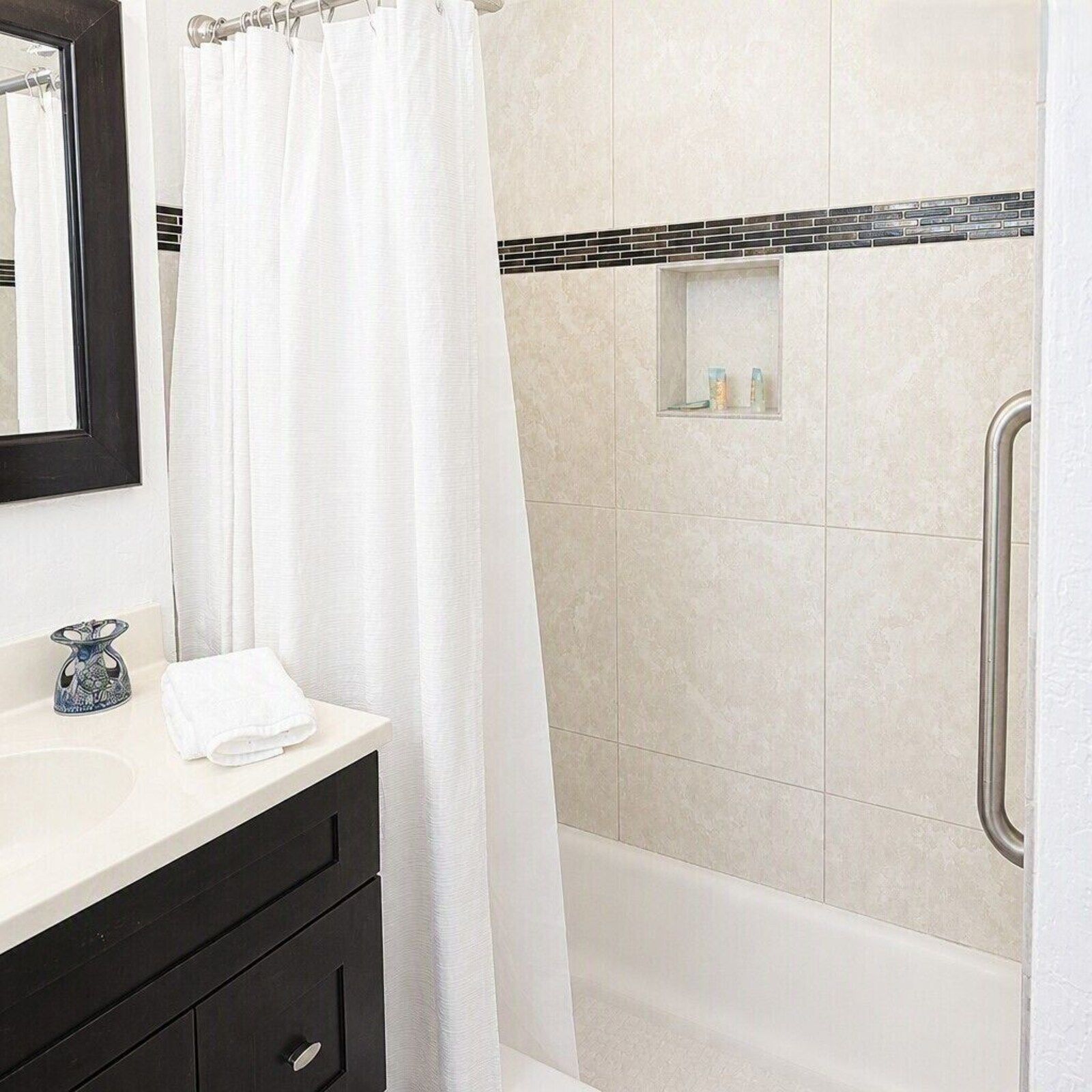 314 bathroom with dark vanity and glass shower