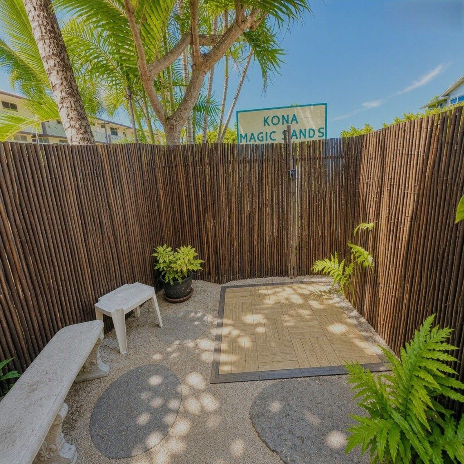 Outdoor rinse shower behind a bamboo fence at Kona Magic Sands